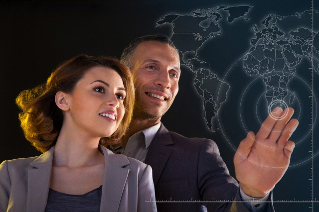 Businesspeople touching world map