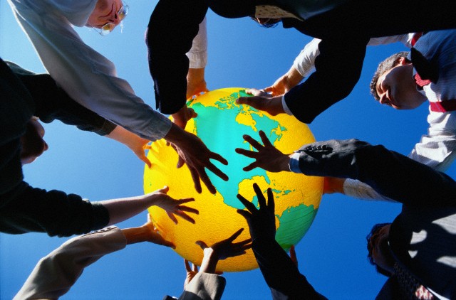 Businesspeople Holding Up a Globe --- Image by © 2/Ryan McVay/Ocean/Corbis