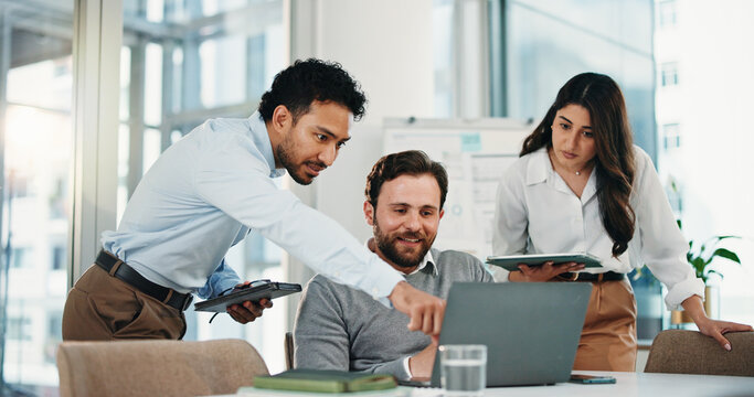 Three people examining computer.
